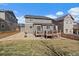 Back exterior view of a two-story home with a deck and a well-maintained lawn at 2028 Treetop Dr, Castle Rock, CO 80109