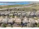 An aerial view showcases neighborhood homes near a lake and highway at 6853 W Rockland Pl, Littleton, CO 80128