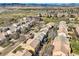 An aerial view showcases homes in a suburban neighborhood with views of open land and mountains at 6853 W Rockland Pl, Littleton, CO 80128