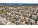 Wide aerial view of a suburban neighborhood with diverse homes, mature trees, and manicured lawns at 6853 W Rockland Pl, Littleton, CO 80128