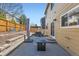 Backyard patio features a dining table, fire pit table, and seating at 6853 W Rockland Pl, Littleton, CO 80128