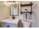 Modern bathroom featuring a stylish vanity and farmhouse-style shelving at 6853 W Rockland Pl, Littleton, CO 80128