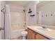 Bathroom has a tub and shower combo with light wood cabinets and neutral finishes at 6853 W Rockland Pl, Littleton, CO 80128