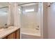 Bright bathroom features a large soaking tub with a shower and neutral finishes at 6853 W Rockland Pl, Littleton, CO 80128