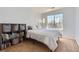 This bedroom offers natural light, neutral walls and a shelving unit with storage at 6853 W Rockland Pl, Littleton, CO 80128