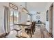Dining space with a large wooden table that flows into the living room at 6853 W Rockland Pl, Littleton, CO 80128