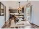 Open-concept kitchen and dining area with modern light fixture and gray cabinetry at 6853 W Rockland Pl, Littleton, CO 80128