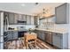 Well-lit kitchen with gray cabinets, stainless steel appliances, and butcher block island at 6853 W Rockland Pl, Littleton, CO 80128