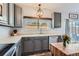 Kitchen featuring gray cabinets, stainless steel appliances, and a window overlooking the backyard at 6853 W Rockland Pl, Littleton, CO 80128