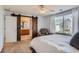Bright main bedroom boasts a ceiling fan and a barn door leading to the ensuite bathroom at 6853 W Rockland Pl, Littleton, CO 80128