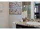 Elegant bathroom vanity with granite countertop, decorative mirror, and modern fixtures at 2442 Champa St, Denver, CO 80205