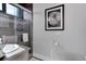 Modern bathroom with a glass-enclosed shower, sleek fixtures, and stylish decor at 2442 Champa St, Denver, CO 80205