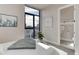 Bright bedroom with a large window offering views of the city, completed with contemporary decor at 2442 Champa St, Denver, CO 80205
