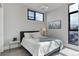 Inviting bedroom featuring a comfortable bed, modern lighting, and city skyline art at 2442 Champa St, Denver, CO 80205