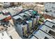 Aerial view of townhome complex featuring modern design, rooftop terraces, and landscaped grounds at 2442 Champa St, Denver, CO 80205