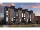 Modern townhome with brick and dark accents, showcasing sleek design and inviting entrances at 2442 Champa St, Denver, CO 80205