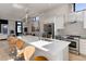 Spacious kitchen featuring a large island, stainless steel appliances, ample counter space, and bar stool seating at 2442 Champa St, Denver, CO 80205