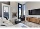 Stylish living room with large windows, a modern fireplace, and neutral decor, creating a comfortable and elegant space at 2442 Champa St, Denver, CO 80205