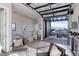 Stylish indoor/outdoor living room with comfortable seating and a glass garage door leading to a deck with city views at 2442 Champa St, Denver, CO 80205