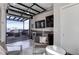Open living space features a full wet bar and an impressive glass garage door opening to the rooftop deck at 2442 Champa St, Denver, CO 80205