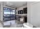 Open living space features a full wet bar and an impressive glass garage door opening to the rooftop deck at 2442 Champa St, Denver, CO 80205