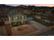 Aerial view of a home with a two-car garage, landscaped yard, and mountain views in the background at 4309 S Coors Ct, Morrison, CO 80465