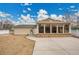 Backyard with concrete patio and sunroom, great for outdoor entertaining and relaxation at 4309 S Coors Ct, Morrison, CO 80465