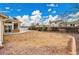 Large, empty backyard with a concrete patio and wood fence, perfect for landscaping and outdoor activities at 4309 S Coors Ct, Morrison, CO 80465