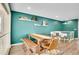 Dining area with a wooden table, bench seating, stylish decor on accent wall, and hardwood flooring at 4309 S Coors Ct, Morrison, CO 80465