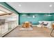 Open-concept dining area with a large wooden table, modern seating, and stylish decor on a vibrant wall at 4309 S Coors Ct, Morrison, CO 80465