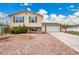 Charming two-story home with a well-maintained yard, concrete driveway, and an attached two-car garage at 4309 S Coors Ct, Morrison, CO 80465