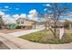 Exterior view of a charming home with a concrete driveway, two-car garage, and well-maintained lawn at 4309 S Coors Ct, Morrison, CO 80465