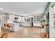 Bright kitchen features white cabinets, a breakfast bar, stainless appliances, and wood flooring at 4309 S Coors Ct, Morrison, CO 80465