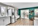 Kitchen with stainless steel refrigerator and white cabinets leading to outdoor dining area at 4309 S Coors Ct, Morrison, CO 80465