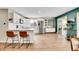 Modern kitchen featuring white cabinets, stainless appliances, and a breakfast bar overlooking the dining space at 4309 S Coors Ct, Morrison, CO 80465