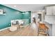 Open living area with hardwood floors, modern furniture, and a vibrant accent wall with decorative shelving at 4309 S Coors Ct, Morrison, CO 80465