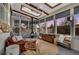 Sunroom features a striking modern fireplace, skylights, and large windows offering natural light and backyard views at 4309 S Coors Ct, Morrison, CO 80465