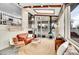 Bright sunroom features a modern fireplace, skylights, spiral staircase, and comfortable seating arrangement at 4309 S Coors Ct, Morrison, CO 80465