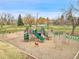 A vibrant community playground featuring swings, slides, climbing structures, and play equipment amidst a grassy area at 4309 S Coors Ct, Morrison, CO 80465