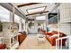 Bright sunroom with large windows, offering a cozy seating area and spiral staircase at 4309 S Coors Ct, Morrison, CO 80465