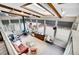 Bright sunroom with multiple windows, a cozy seating area, and unique architectural details at 4309 S Coors Ct, Morrison, CO 80465