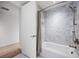 Bathroom boasts shower and tub with decorative gray tile surround at 1750 Wewatta St # 1536, Denver, CO 80202