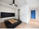 Bedroom with a walk-in closet, wood floors, and a ceiling fan at 1750 Wewatta St # 1536, Denver, CO 80202