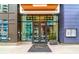 Modern building entrance featuring glass doors, a branded welcome mat, and sleek architectural details at 1750 Wewatta St # 1536, Denver, CO 80202