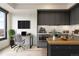 Modern eat in kitchen with sleek cabinets, stainless appliances, and adjacent workspace at 1750 Wewatta St # 1536, Denver, CO 80202