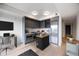 Contemporary kitchen with grey cabinetry, island, and stainless steel appliances at 1750 Wewatta St # 1536, Denver, CO 80202