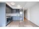 Contemporary eat in kitchen with stainless appliances, island, and hardwood flooring at 1750 Wewatta St # 1536, Denver, CO 80202