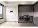 Contemporary eat in kitchen featuring stainless steel appliances and undermount lighting at 1750 Wewatta St # 1536, Denver, CO 80202