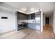 Modern kitchen with gray cabinetry, stainless steel appliances, and hardwood floors at 1750 Wewatta St # 1536, Denver, CO 80202