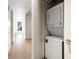 Laundry area with a stacked washer and dryer unit in the hallway at 1750 Wewatta St # 1536, Denver, CO 80202